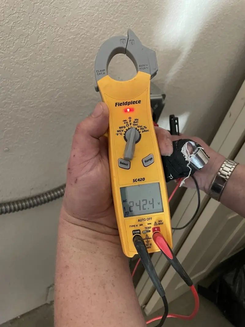 Voltage testing with clamp meter during Electrical Installation Services in Ridge Manor